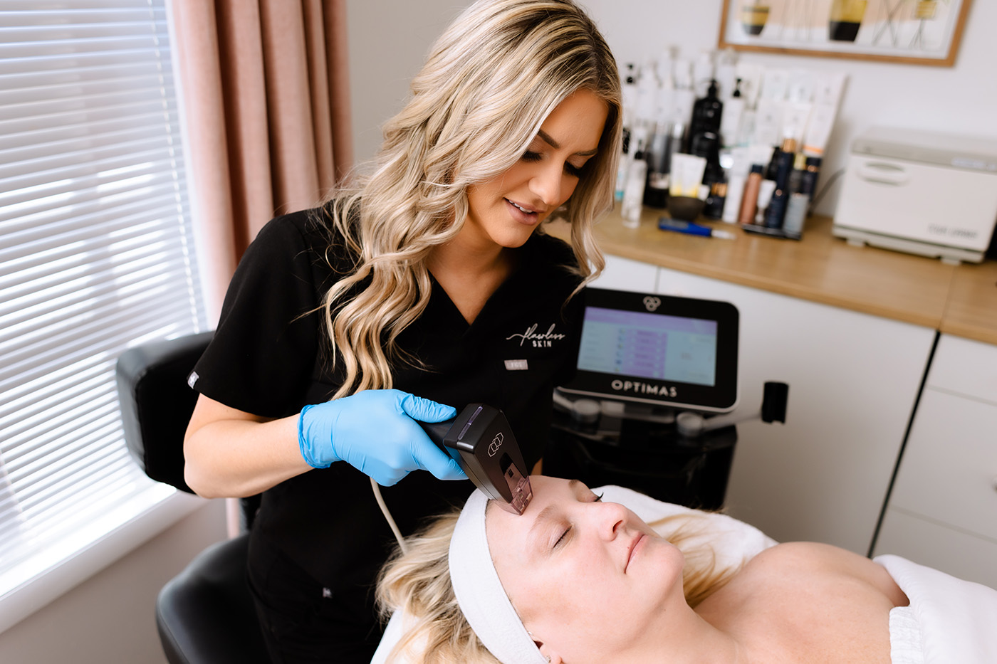 Owner and Master Esthetician, Alexis Hoggard, performing advance skincare of Morpheus8 service on a client