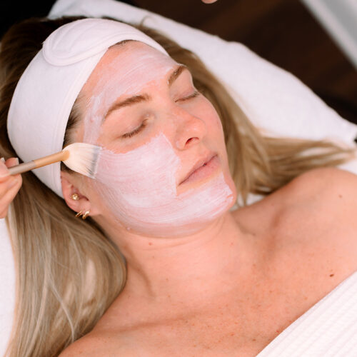 Woman client receiving a facial spa service.