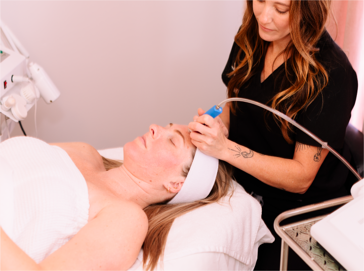 female ethician performing facial procedure on a client